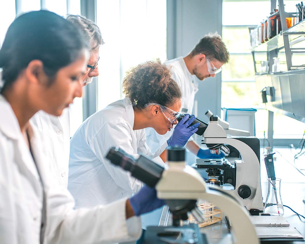 A person looking into a microscope.