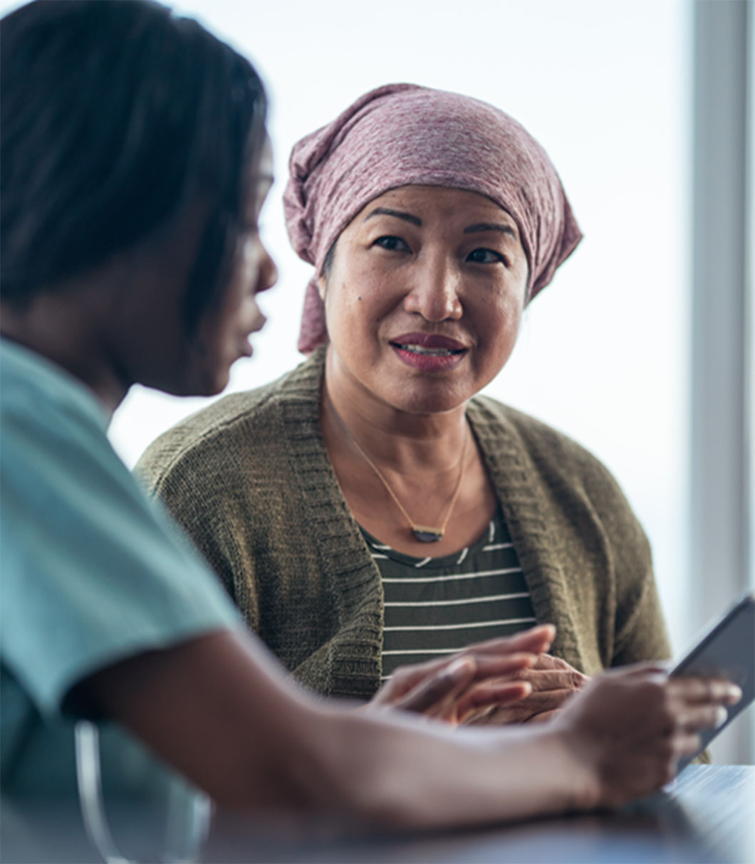 two women reviewing information on a tablet